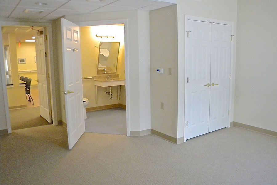 An empty room with a bathroom and a sink