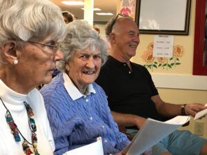 A group of elderly people are sitting in a room.