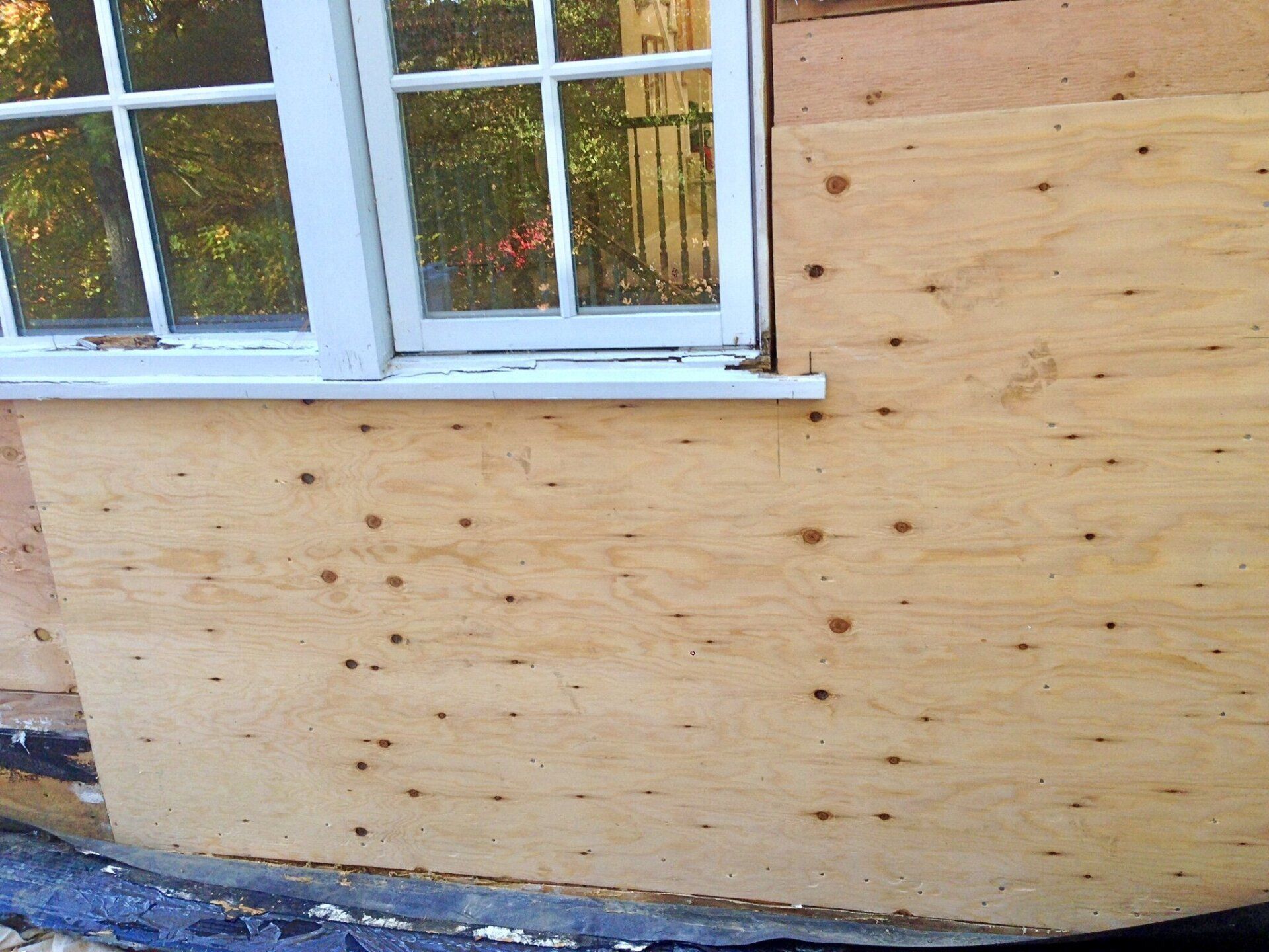 A wooden wall with a window in it