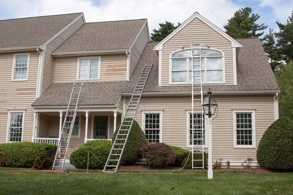 A house with a ladder on the side of it