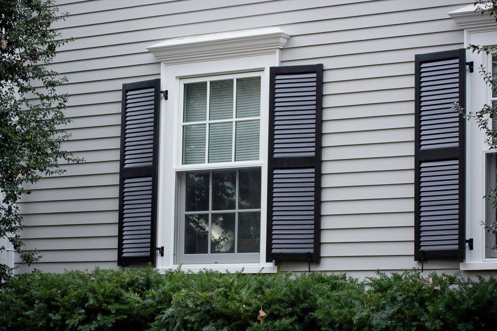 A white house with black shutters on the windows