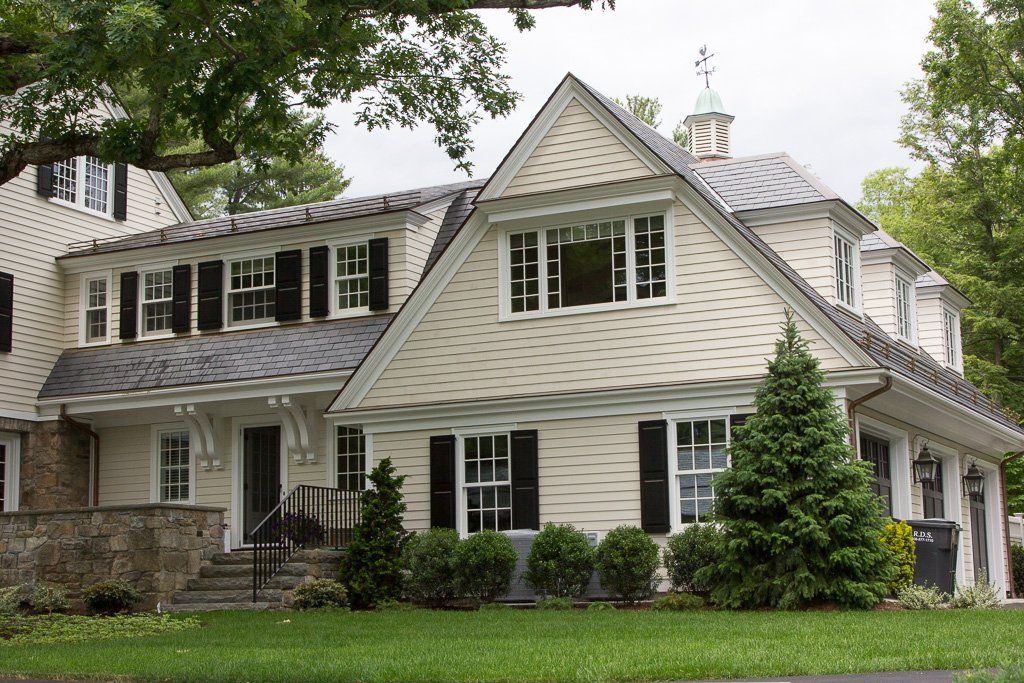 A large white house with black shutters on the windows