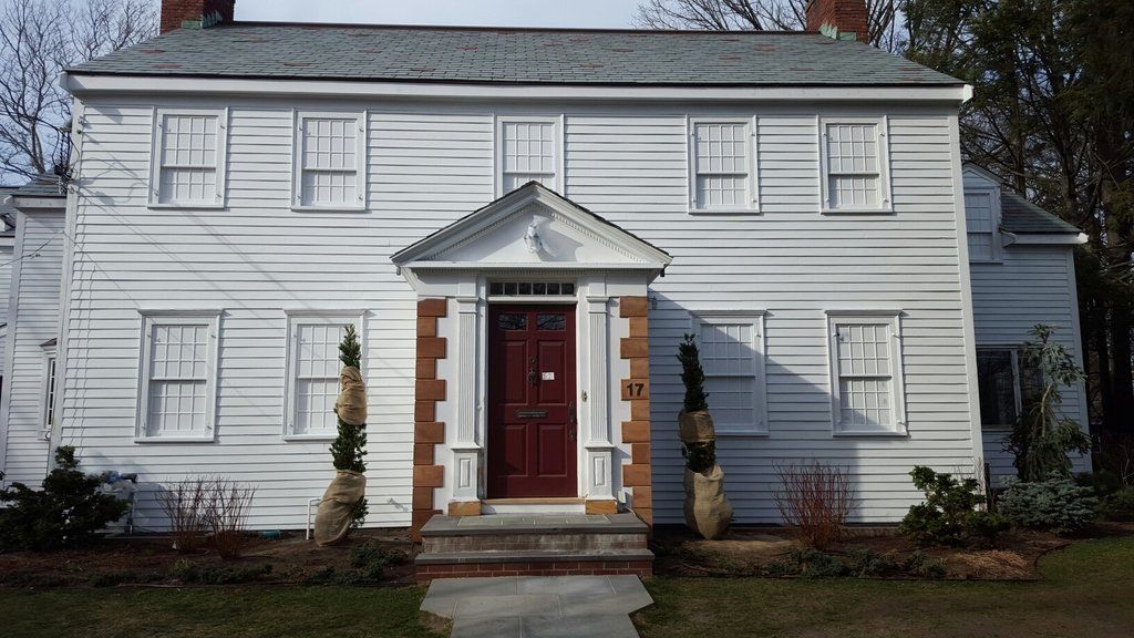 A large white house with a red door