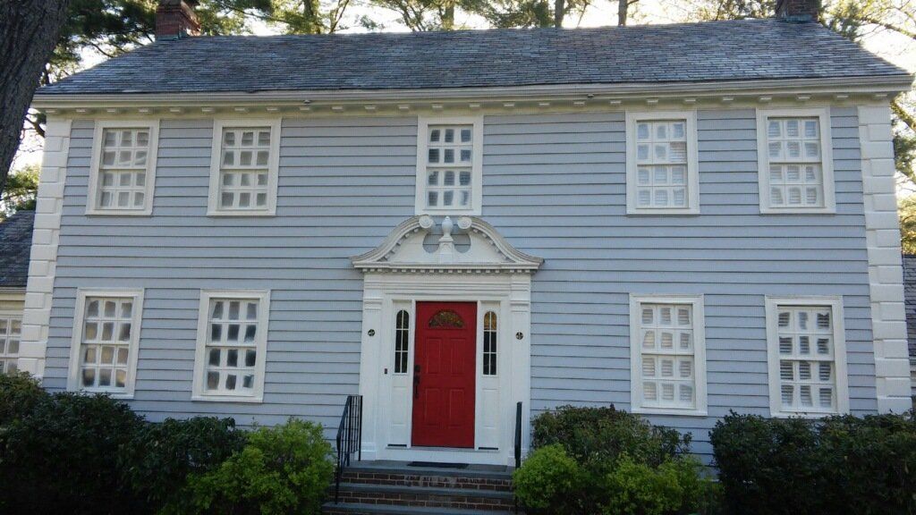 A large house with a red door and white trim.