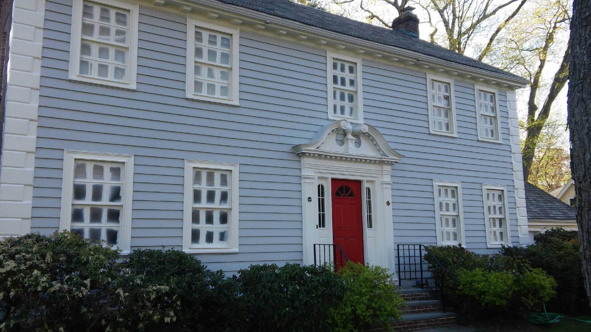 A large house with a red door and white trim