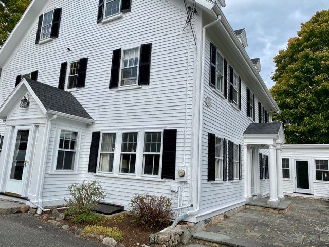 A white house with black shutters on the windows