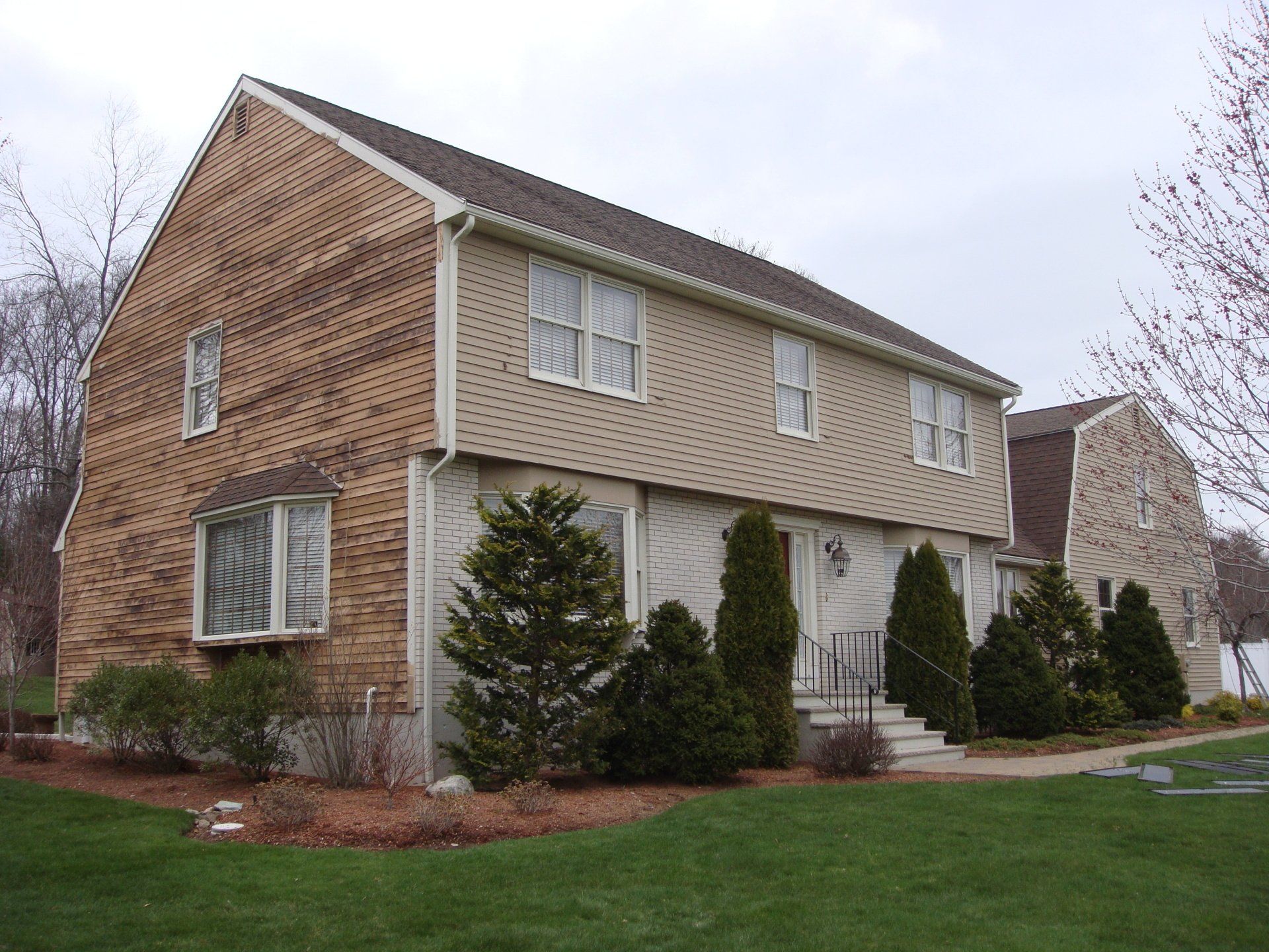 A house with a lot of windows and trees in front of it