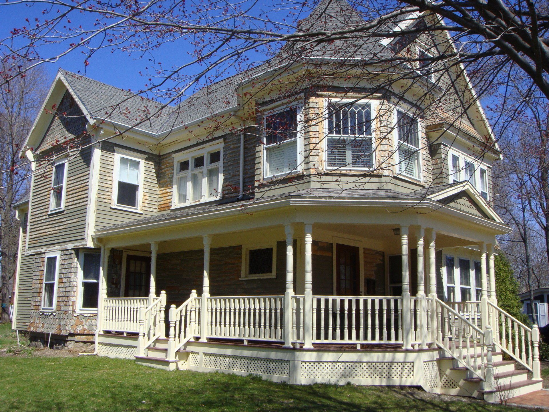 A large house with a large porch and stairs