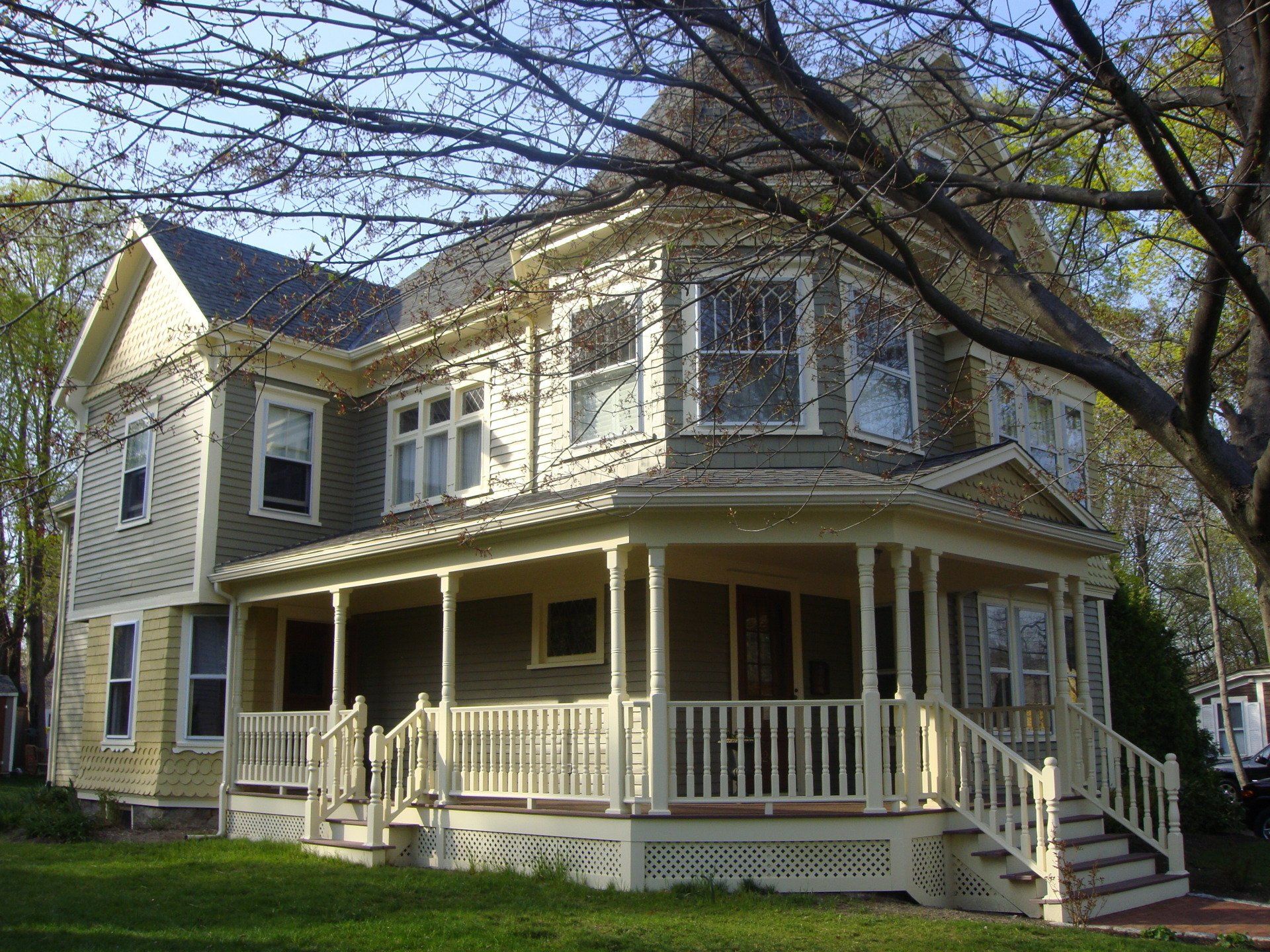 A large house with a large porch and stairs