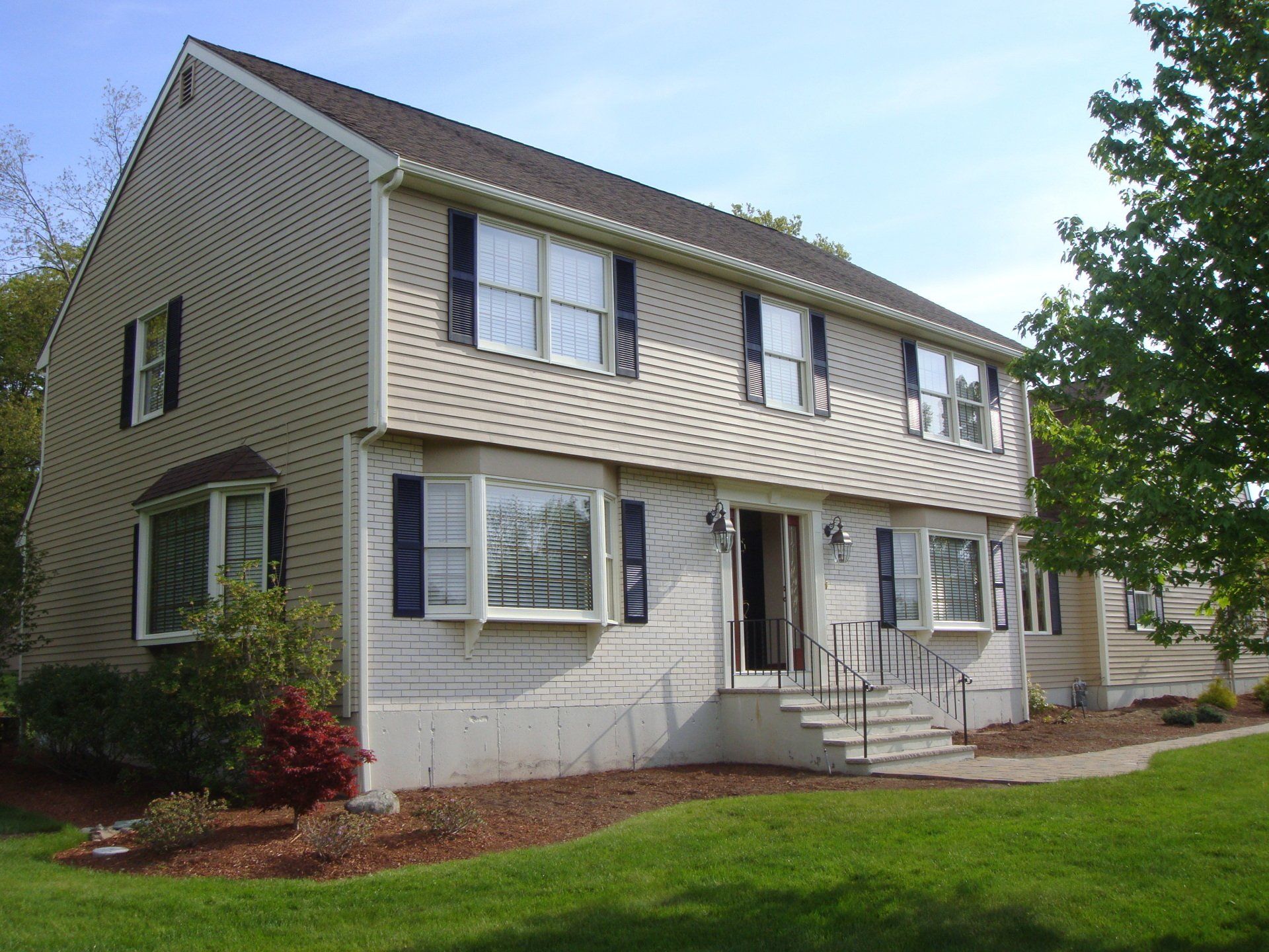 A house with a lot of windows and black shutters