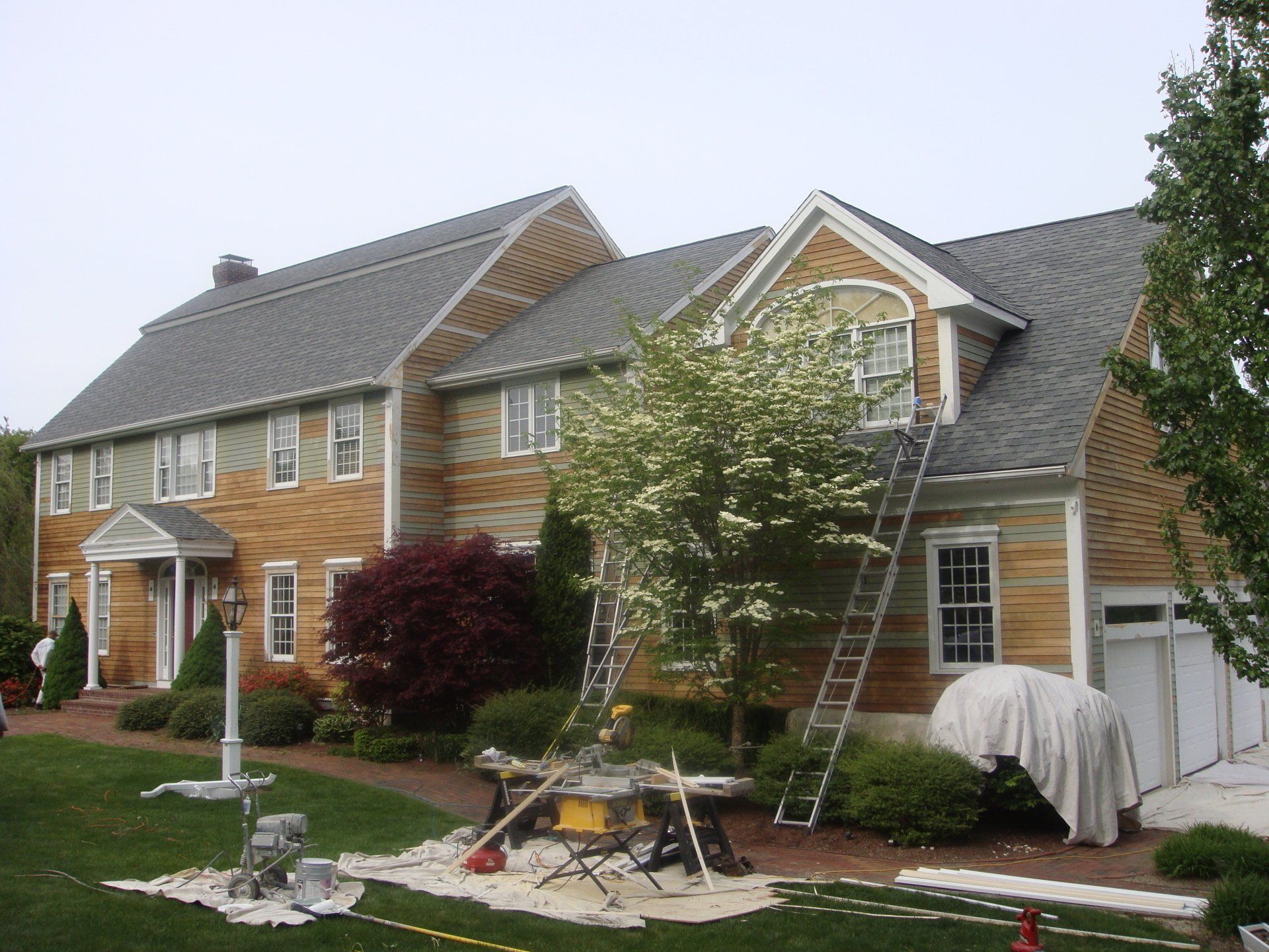 A large house with a ladder in front of it