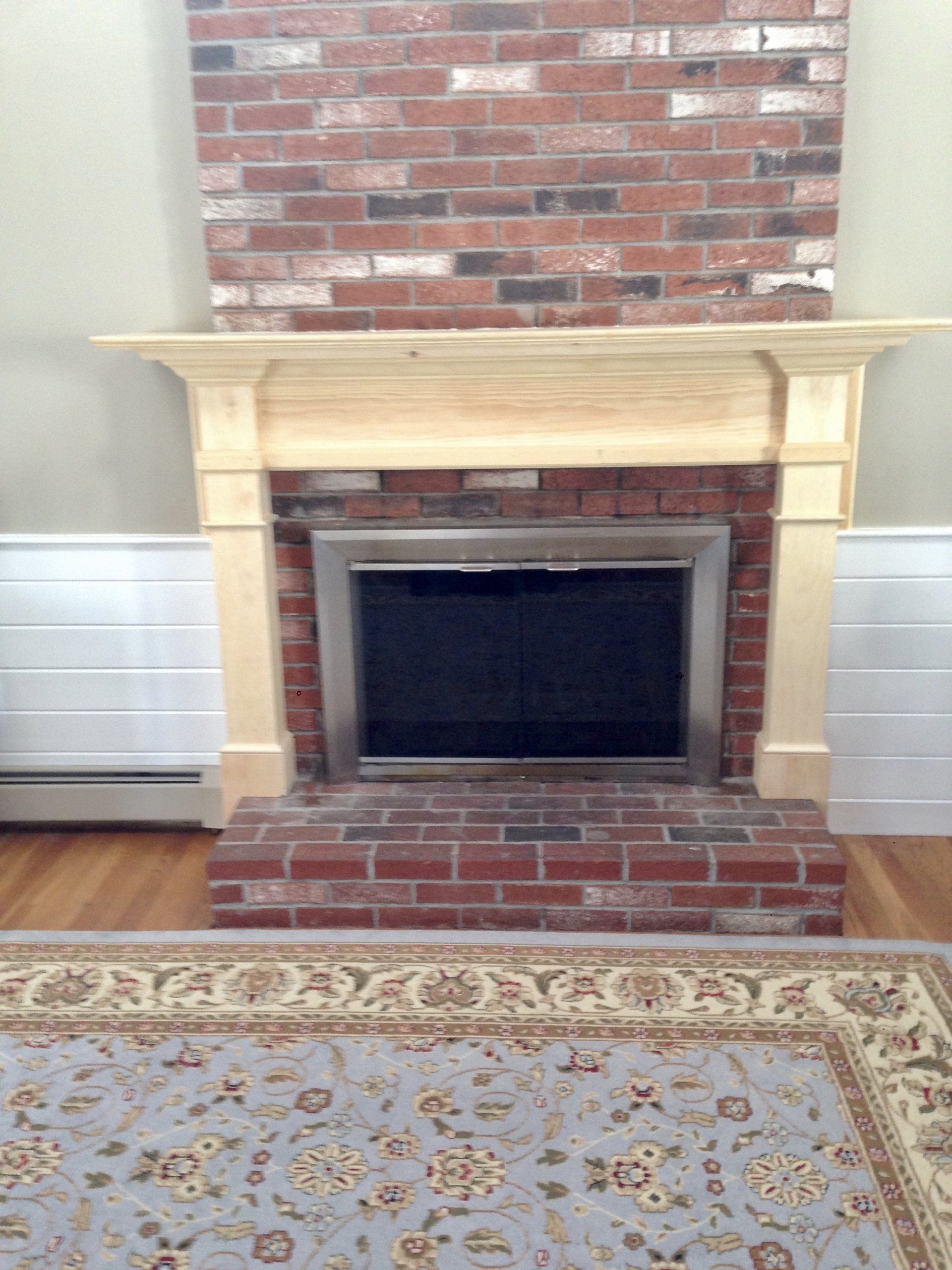 A living room with a brick fireplace