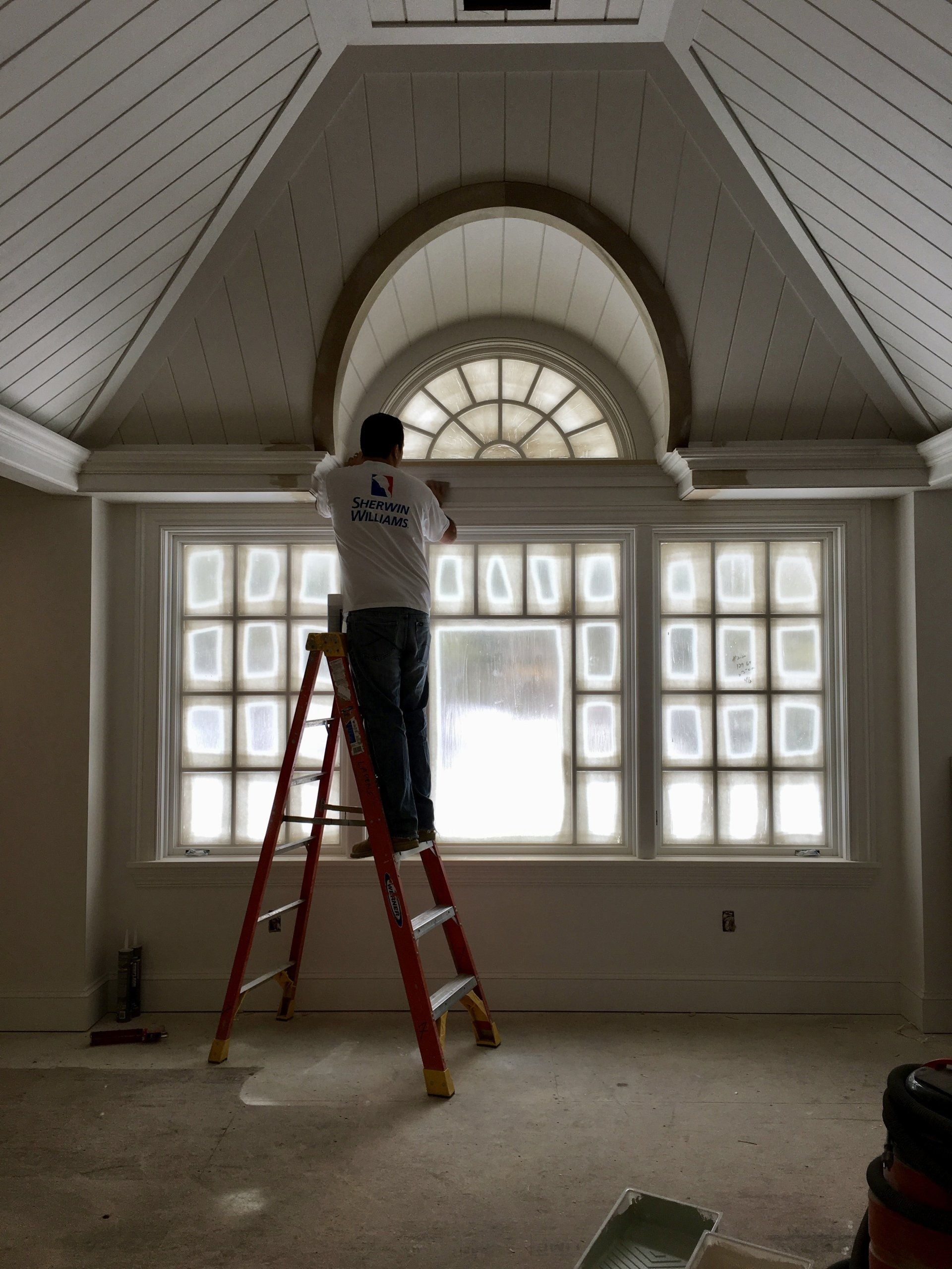 Interior of home being painted by a worker