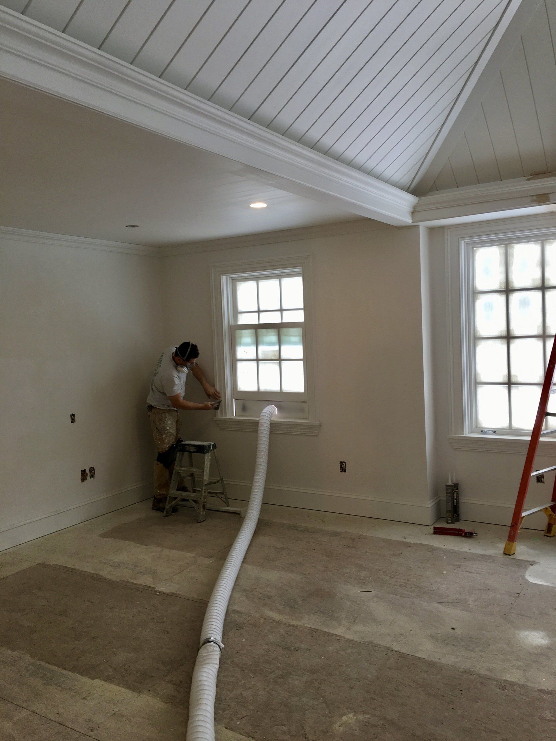 Painter preping wall for interior painting