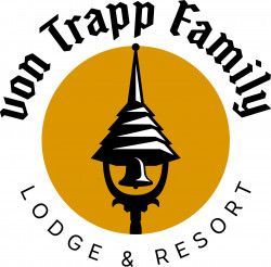 Person riding a mountain bike on a dirt trail through a lush green forest.