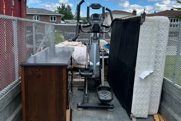 mattress, elliptical, and dresser in trailer, household junk removal