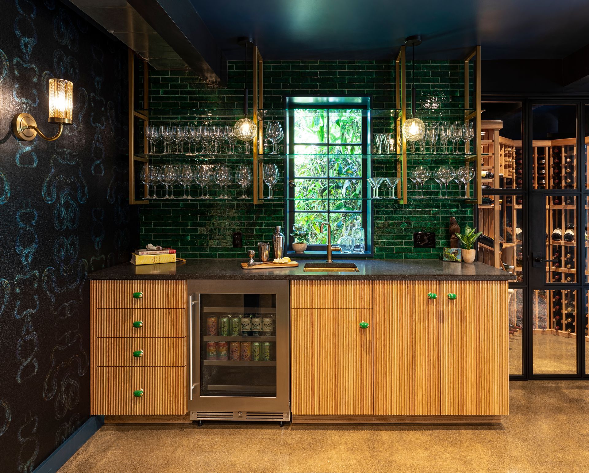 Custom basement bar with tambor front cabinets and brass shelving.