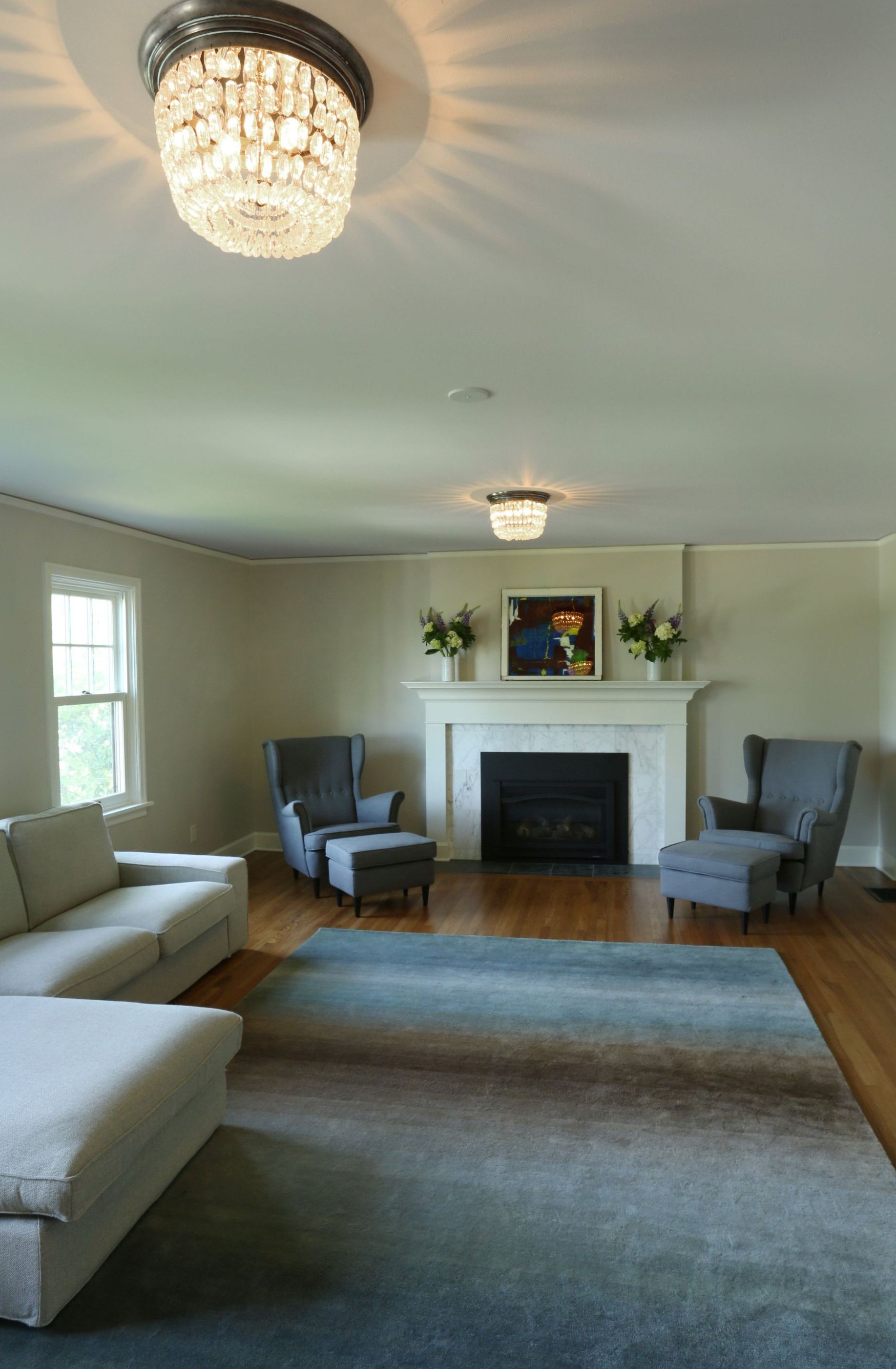 A living room with a couch , chairs and a fireplace