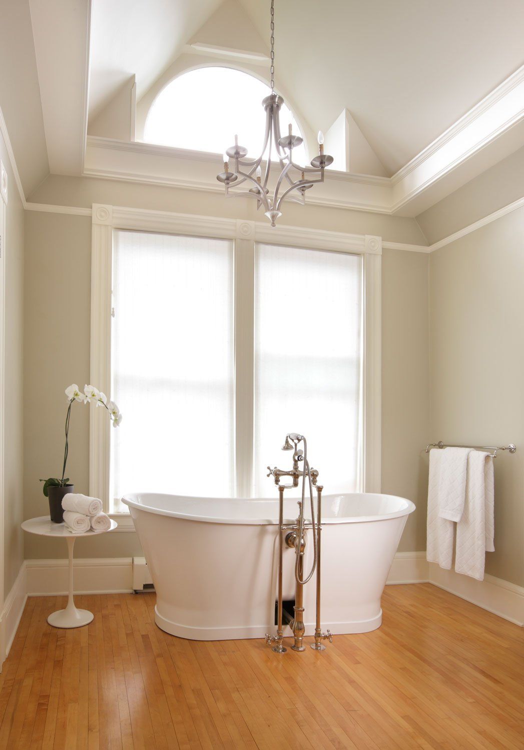 The new main bath has vaulted ceilings, large windows and a freestanding tub.