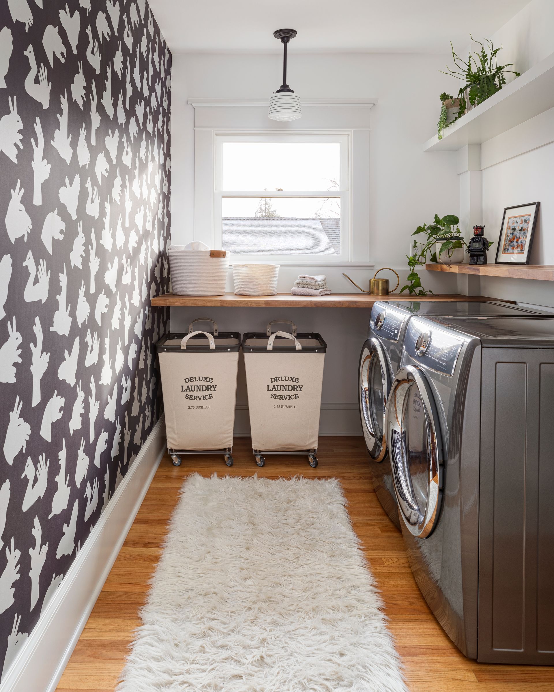 A new laundry room within a former bedroom features shadow puppet wallpaper.