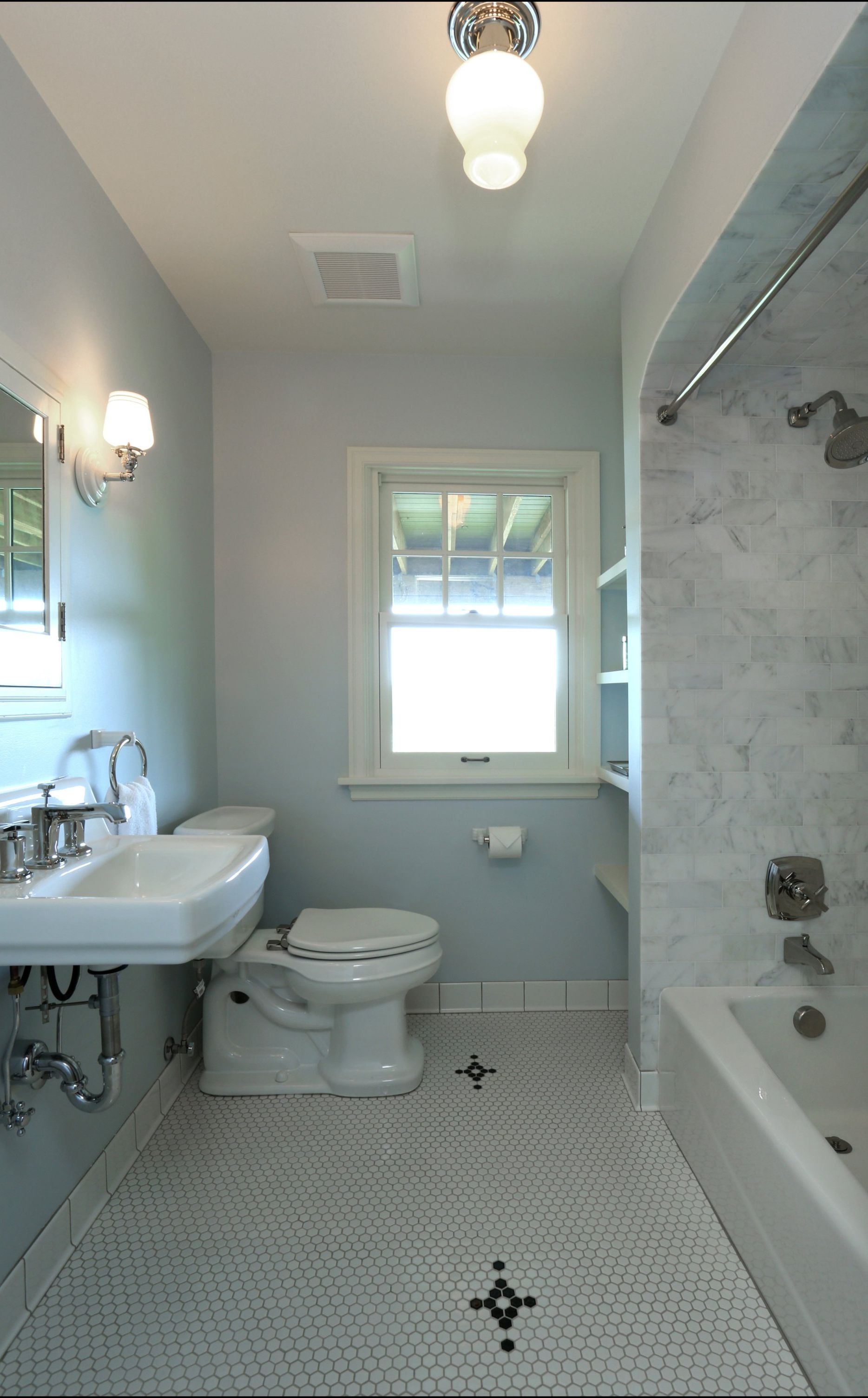 A bathroom with a toilet a sink and a bathtub