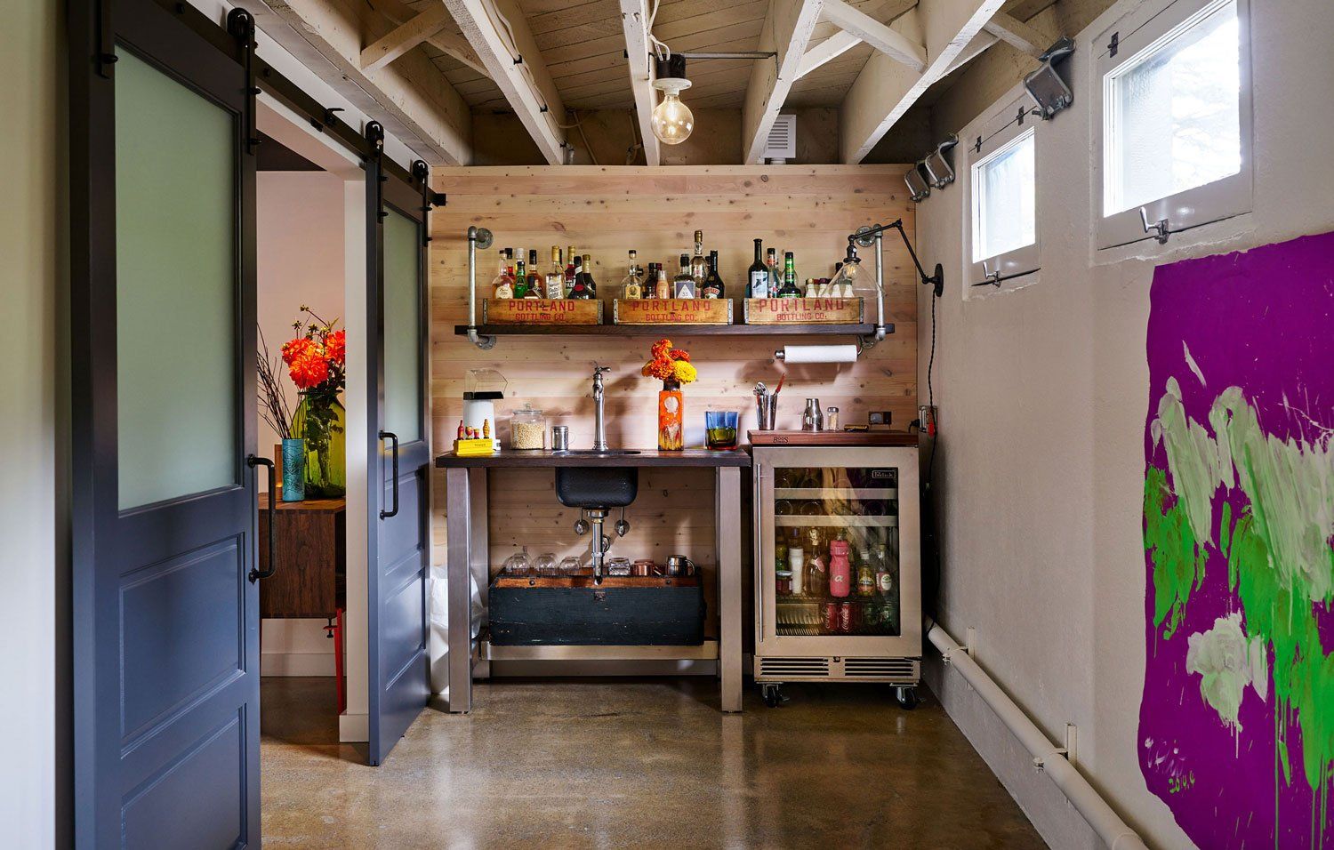 Spruce paneled walls define the wet bar and restored windows bring in natural light.