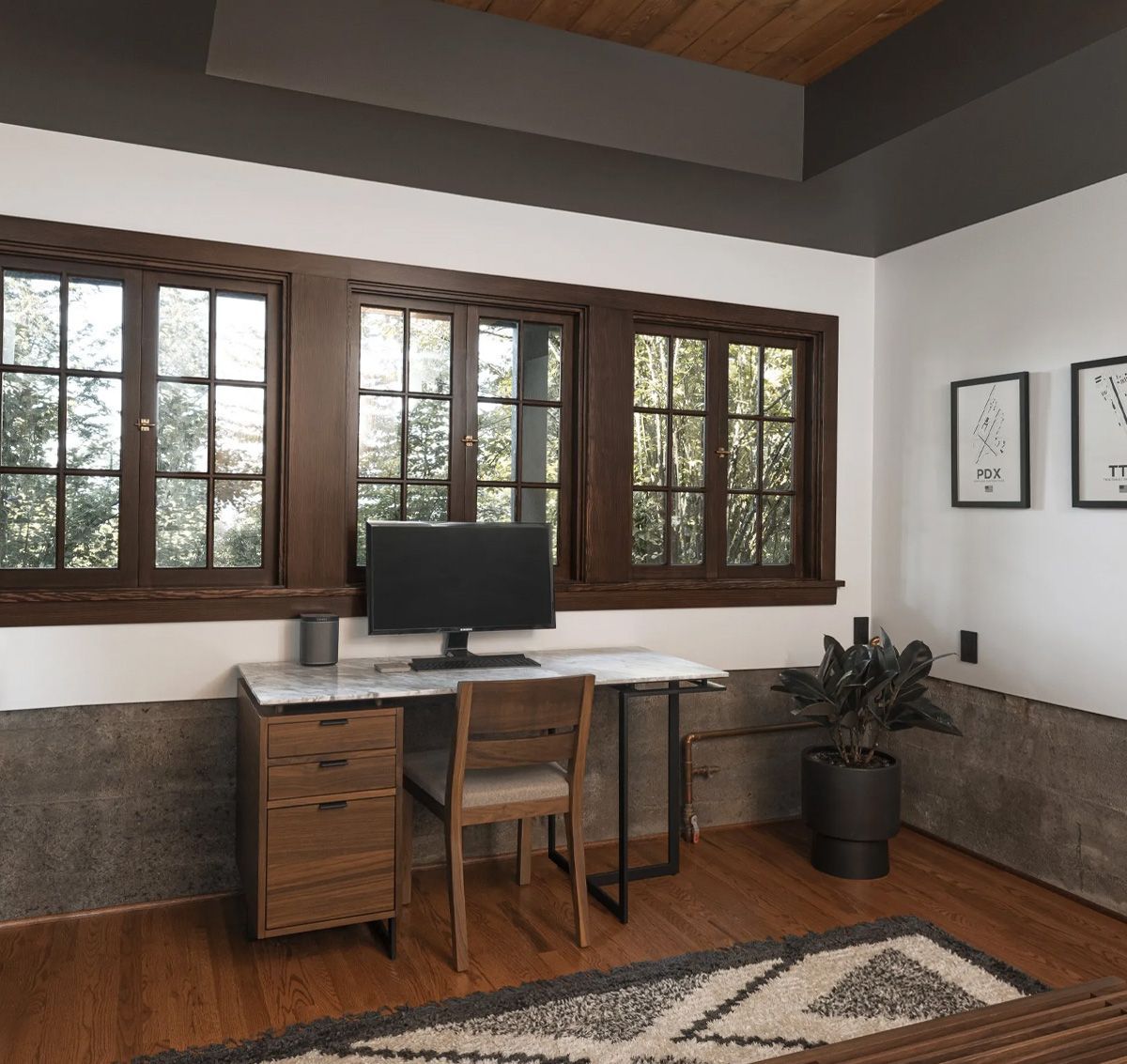 Set on a steep slope, the basement of this 1930s Tudor featured many large windows - making this space ideal for a combination home office/guest room.