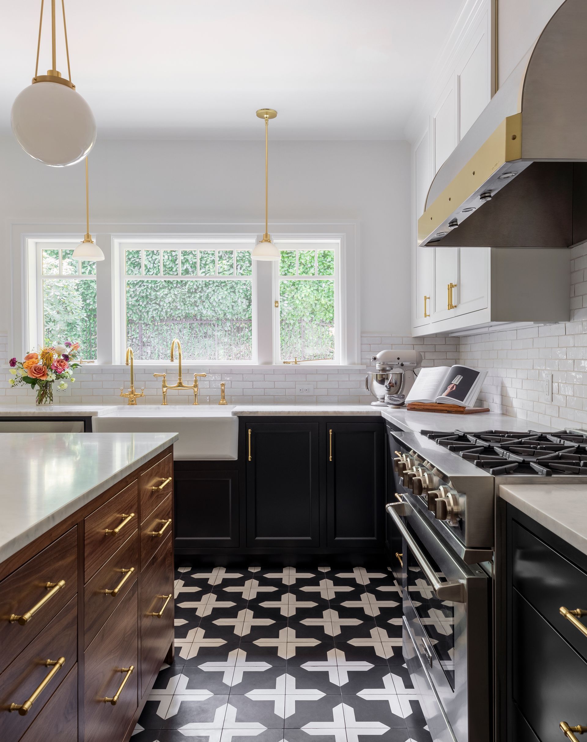 The new shower gleams, clad in white zellige tile with brass fixtures.