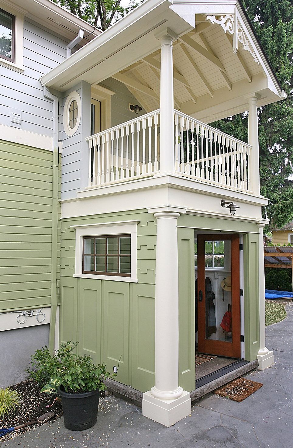A two-story addition and a mudroom with balcony sits off the driveway