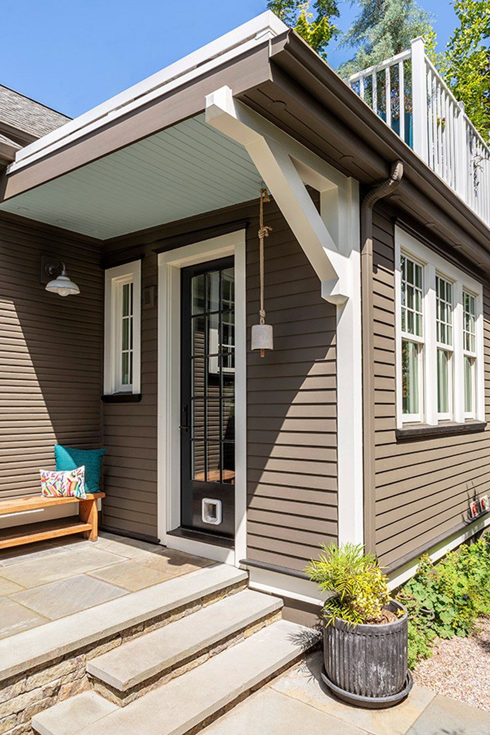 The addition includes a balcony and side porch that leads from the outdoor living room to the pretty mudroom.