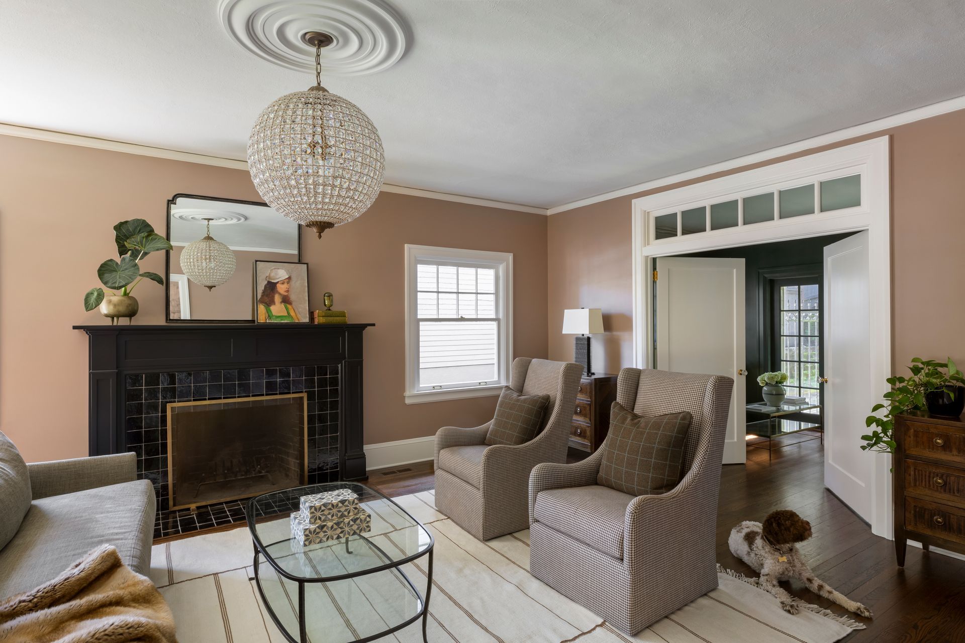 New doors with a transom window connect a serene living room with the parlor.