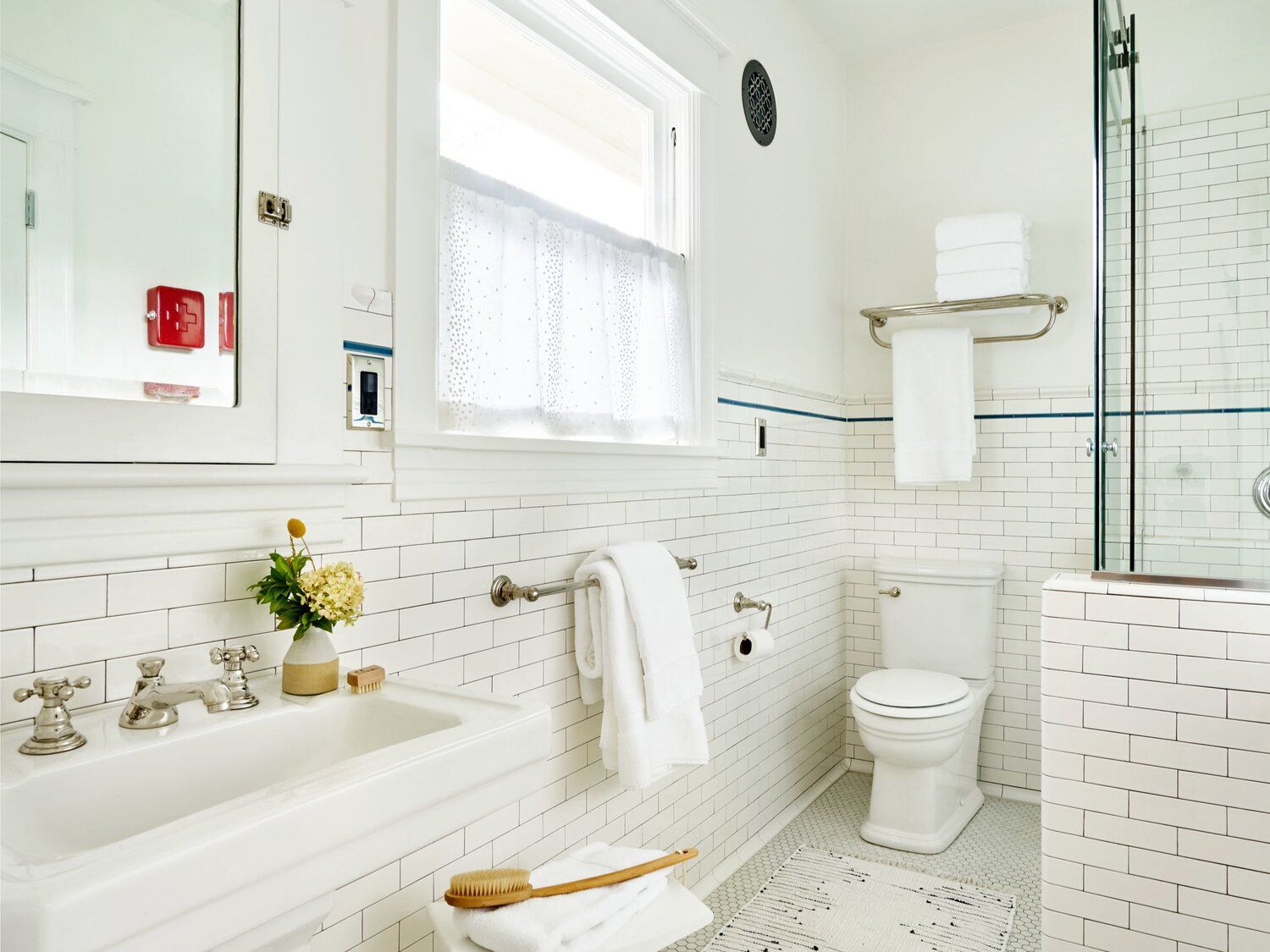 In the main floor bath, we replaced the tub with a shower and installed all new wall tile.