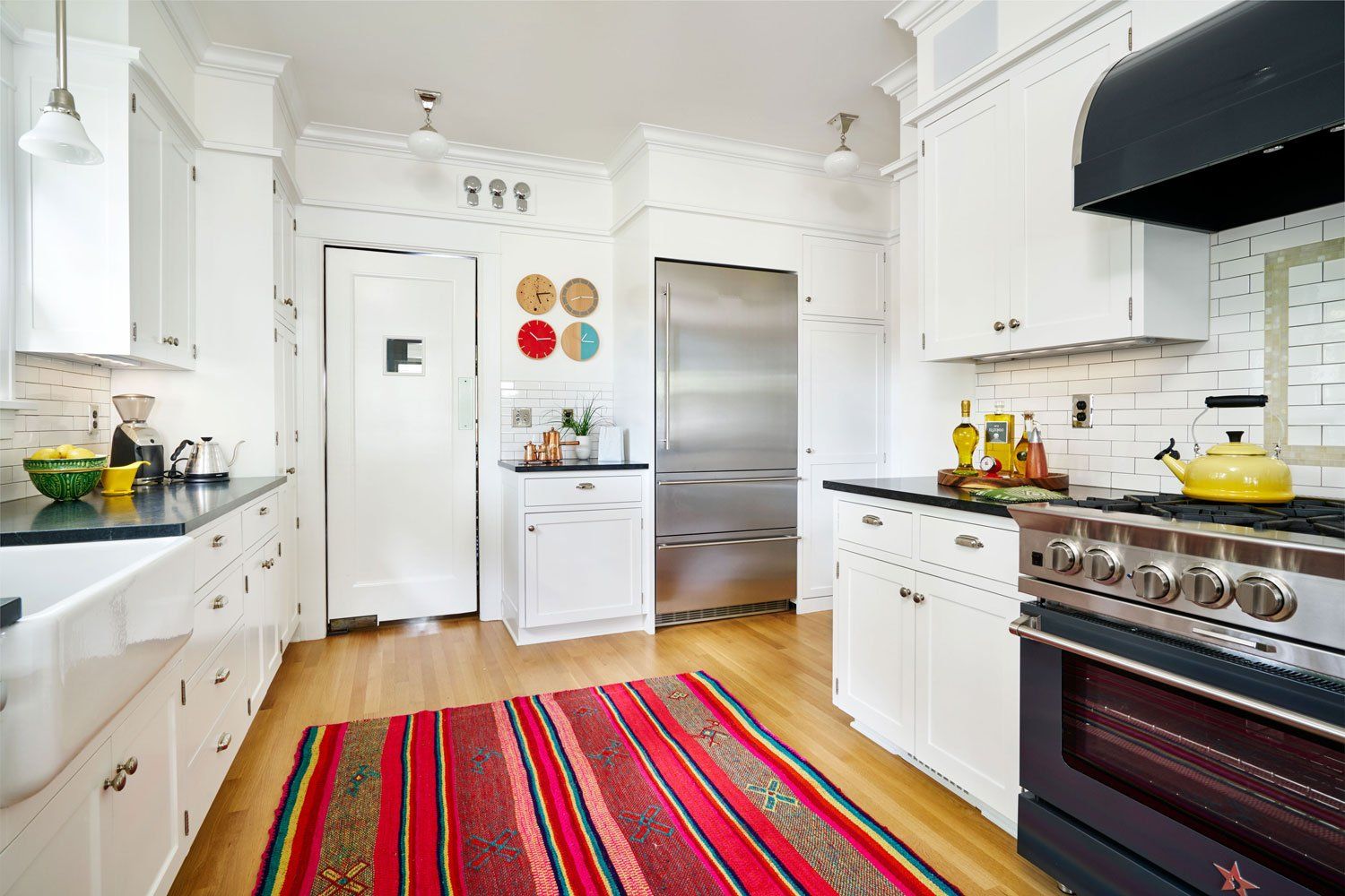 The majority of kitchen cabinets were kept but painted. We added new soapstone counters and period appropriate subway tile. All fixtures and appliances are new.