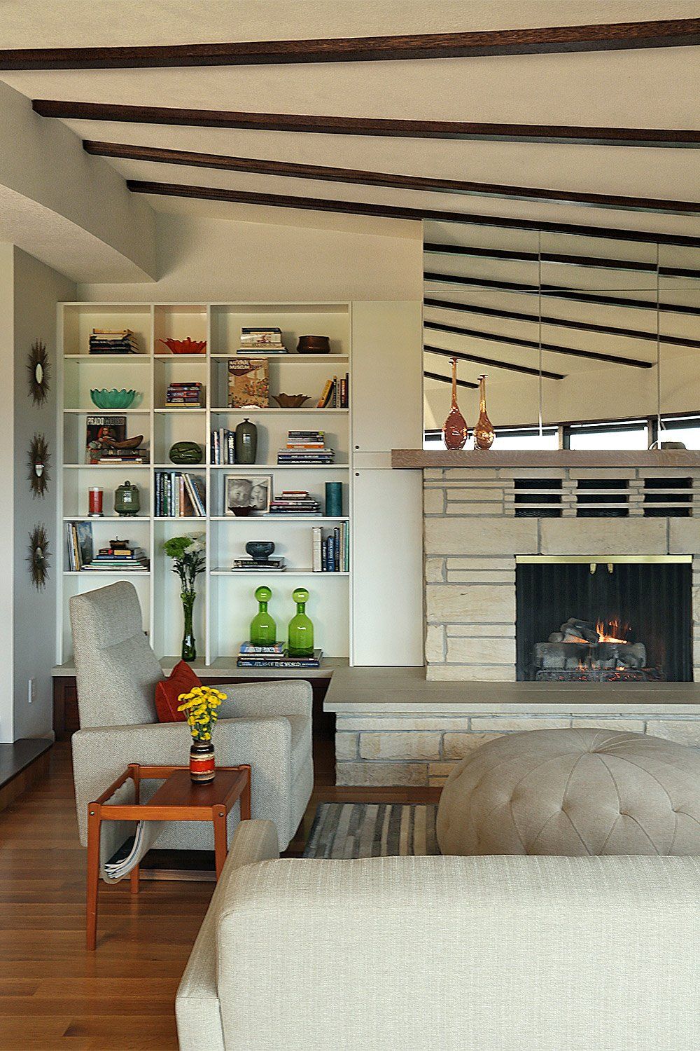 A new mirror above the fireplace reflects the iconic ceiling ribs