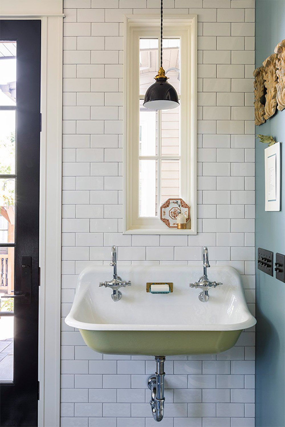 A utilitarian wall mounted sink charms with its spring green belly.