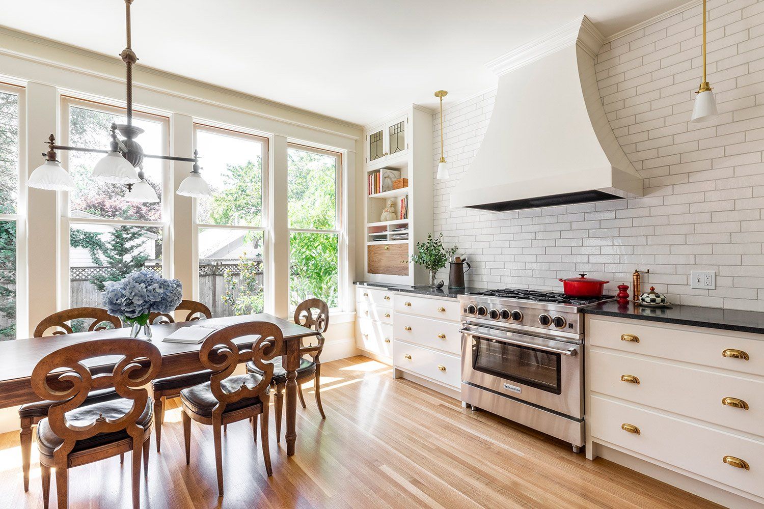 Pretty and practical, the fresh white kitchen has plenty of storage, prep areas and dining space for the family