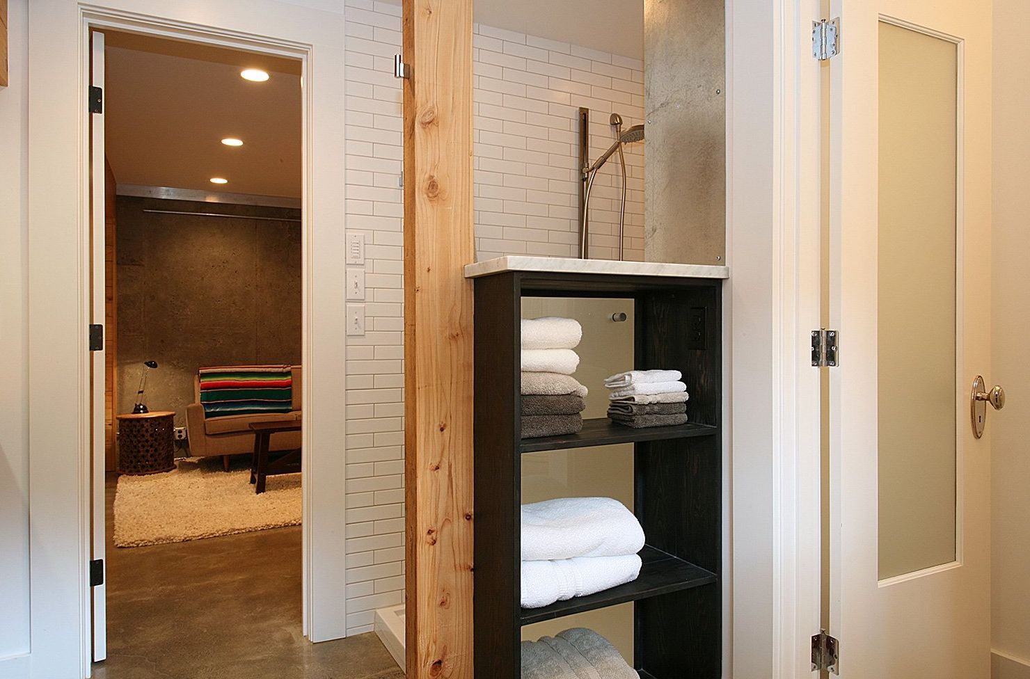 The new basement bath has a shower, toilet room, shelving and laundry closet