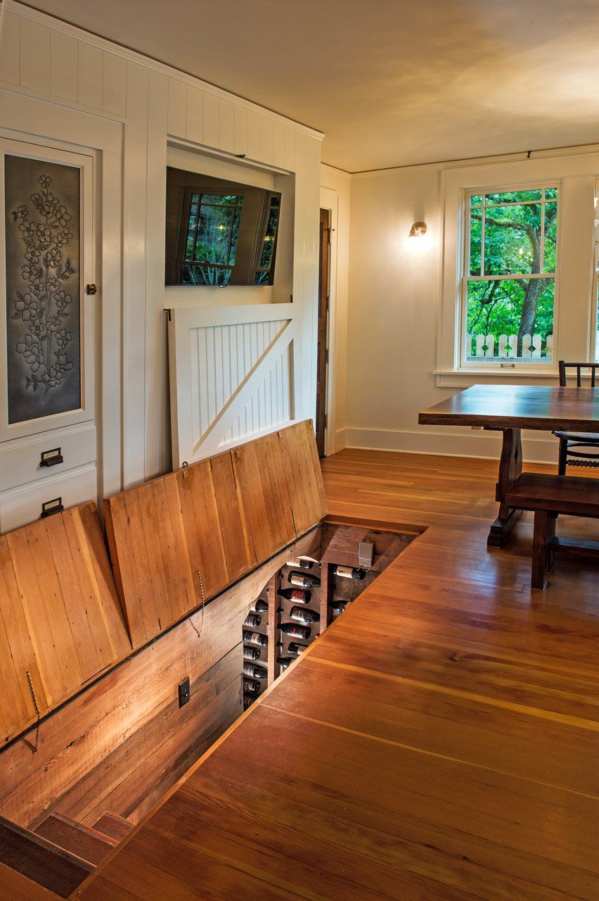 In the kitchen, the original back stairs are now the wine cellar, accessed through hatches in the floor.
