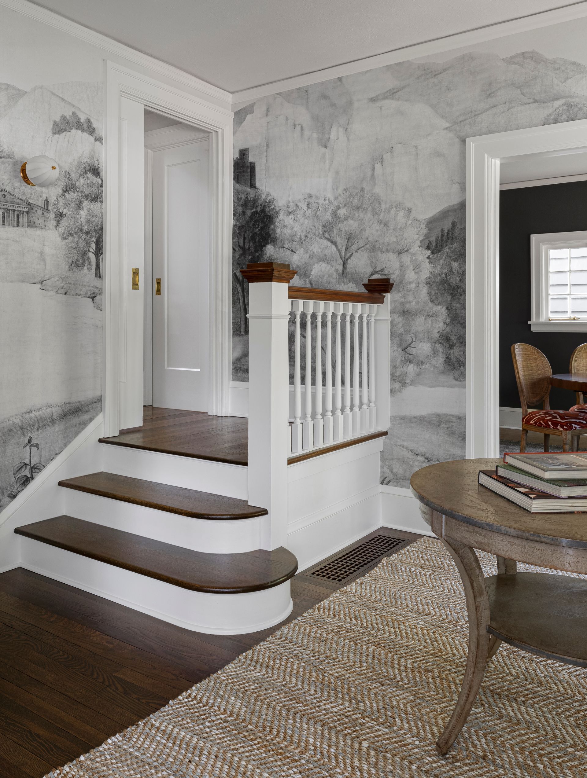 An atmospheric wallpaper mural wraps the entry - selected by designer Bradley Odom.