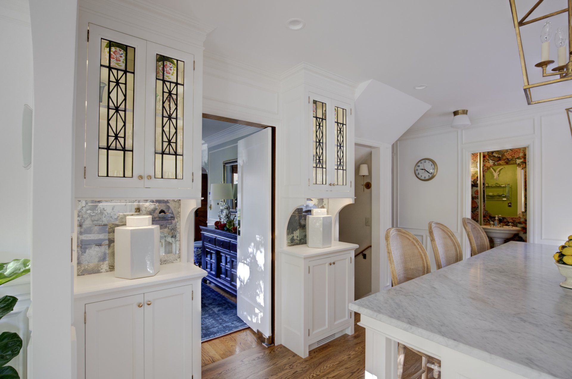 Custom full inset cabinets by Arciform have leaded glass doors at uppers and antiqued mirrrors at the backsplash.
