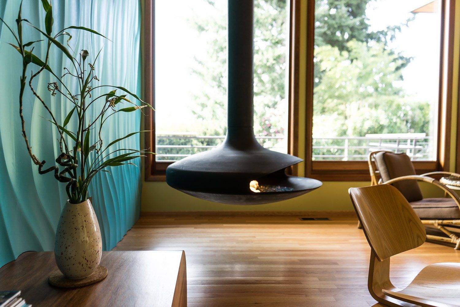 A new window & door wall maximizes city views while a black gyro focus fireplace lends drama & warmth inside.