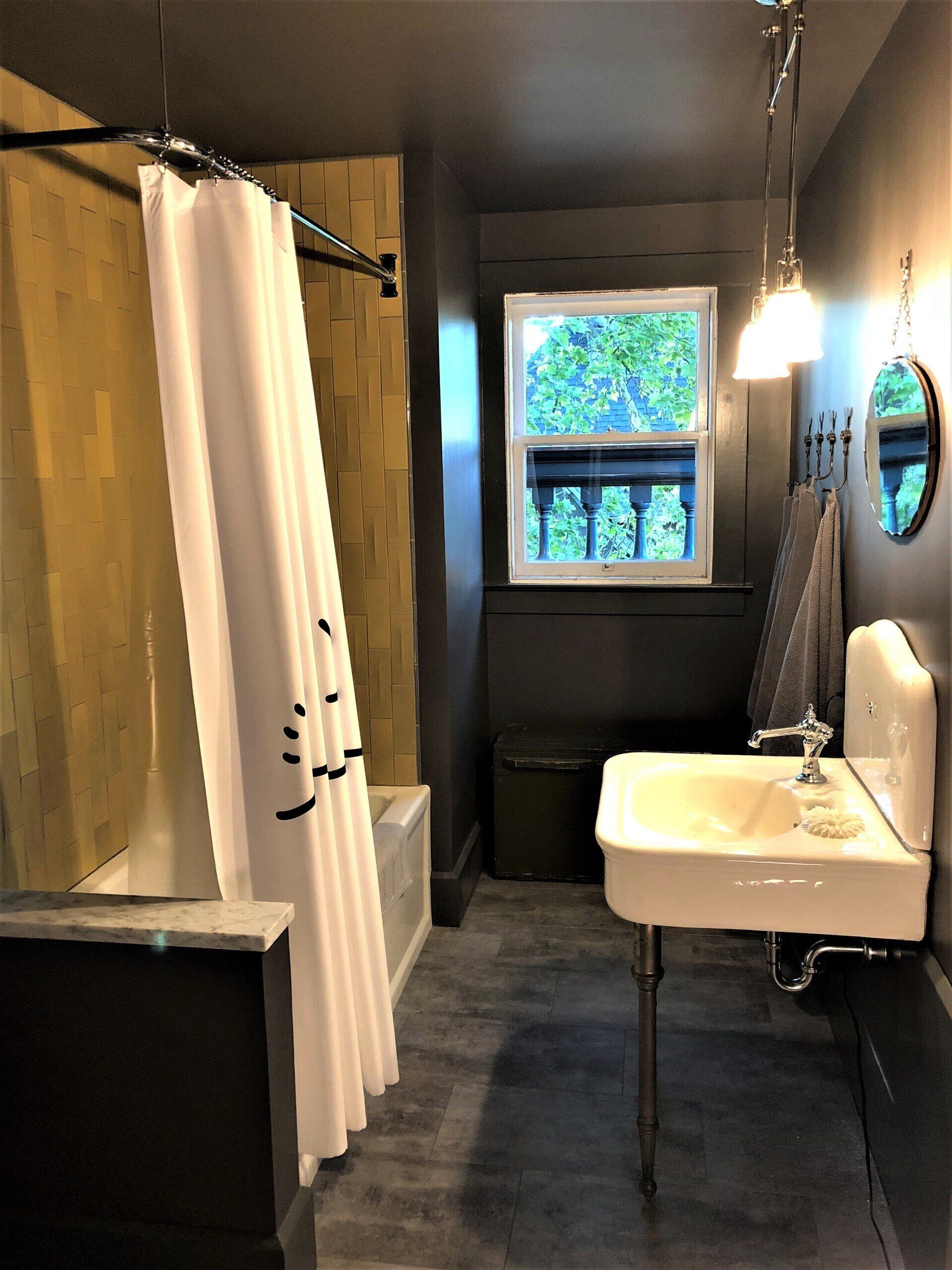 A bathroom with a sink and a shower curtain