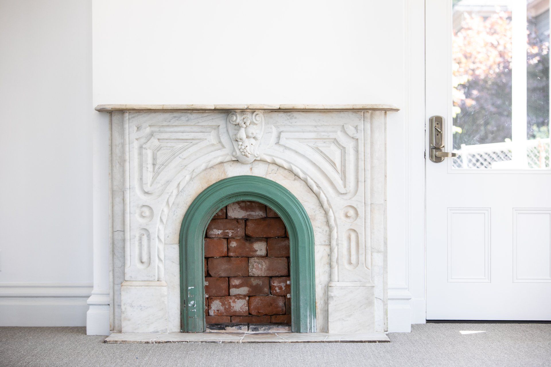 The original marble fireplace surround was painstakingly restored by site lead Jack Ouska.