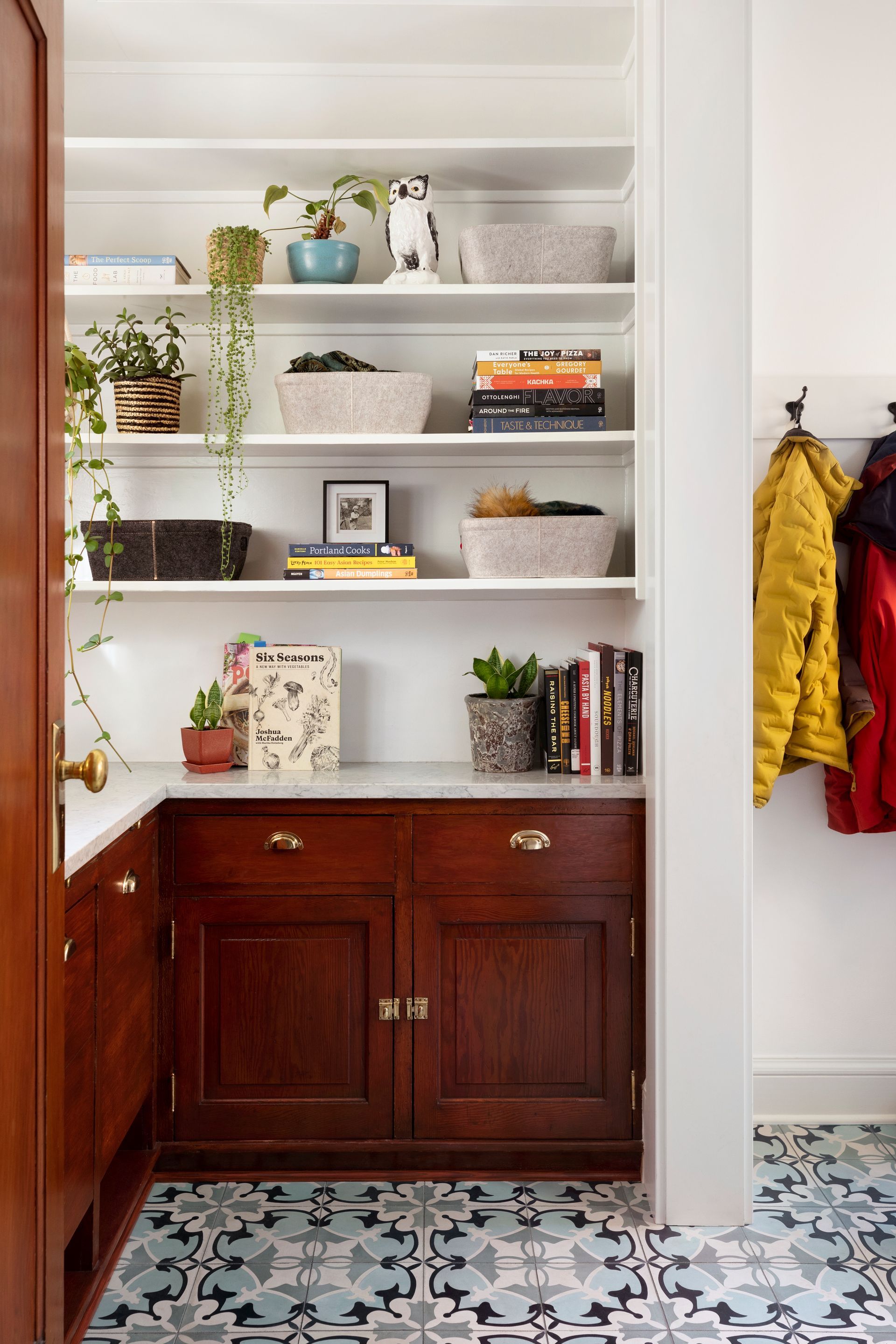 A refurbished pantry now doubles as side entry with new concrete tile floors and a Carrara counter. 