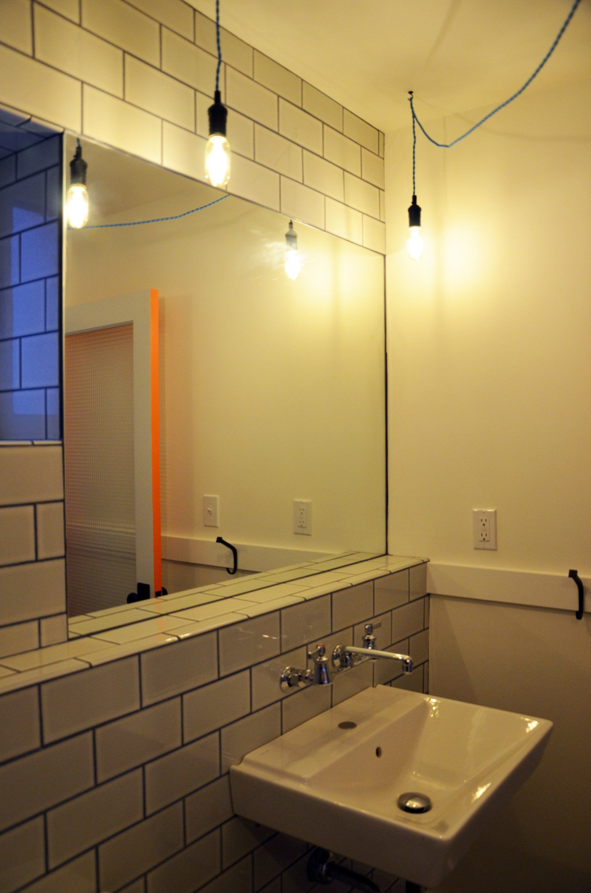 A bathroom with a sink and a large mirror