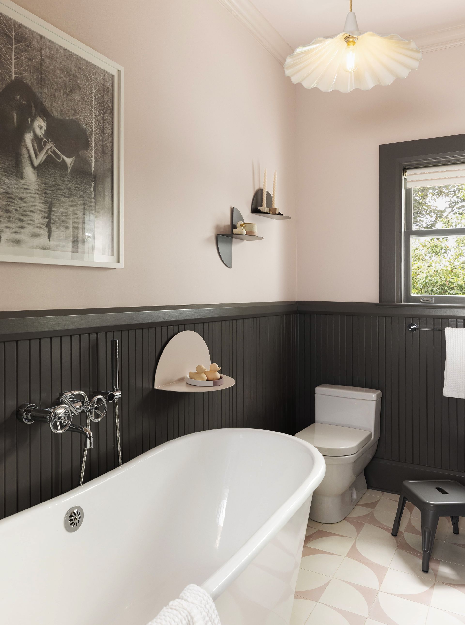 Remodeled 1920’s pink bathroom with pedestal tub and pink and white concrete tile floor.