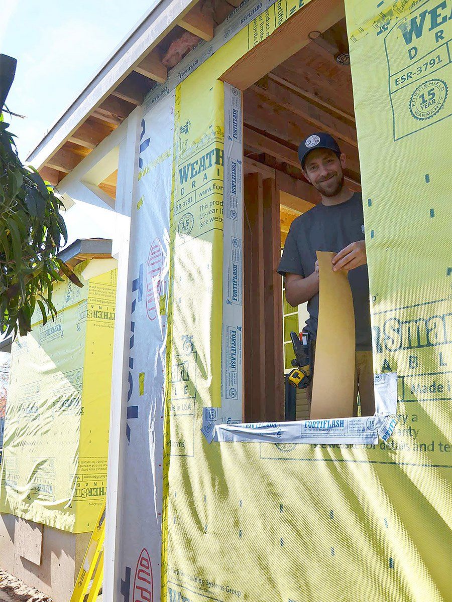 ARCIFORM Carpenter makes the most of a dry sunny day at this addition, prepping for windows