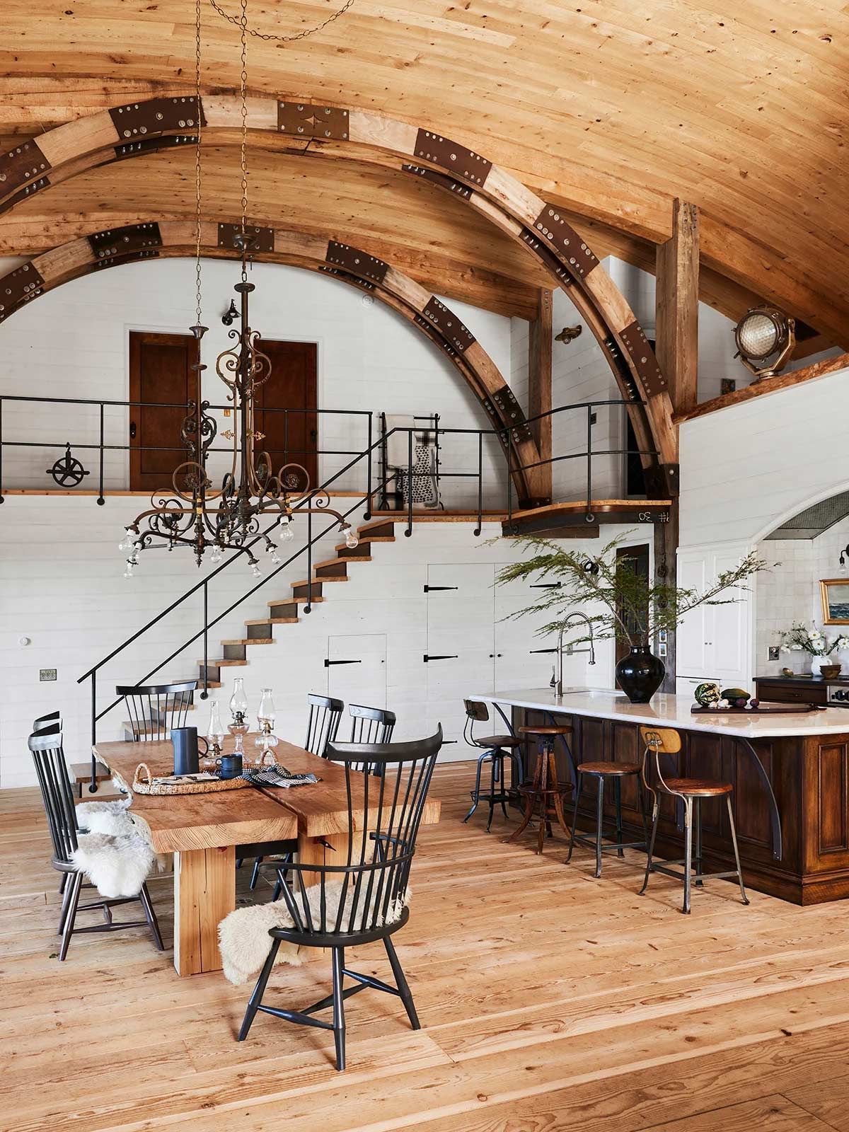 A large room with a wooden table and chairs in it