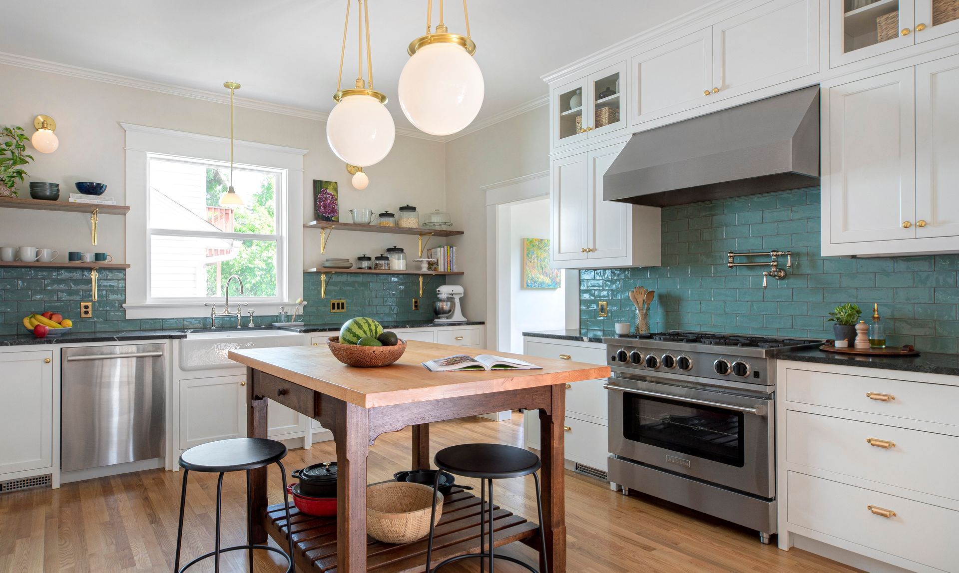 In this circa 1915 home, Arciform increased the kitchen's size by integrating smaller adjacent spaces and introduced new cabinetry that reflects the home's Arts & Crafts style.
