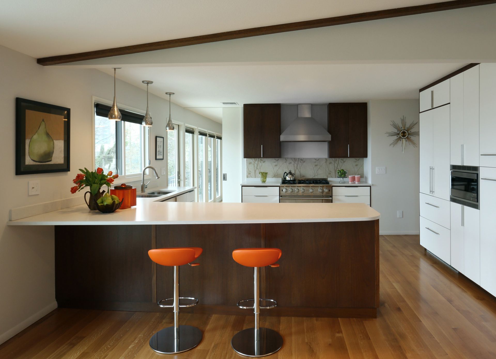 Looking over the island and into the crisp and clean kitchen